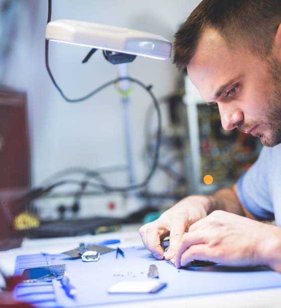 man-repairing-smartphone-at-workplace-2023-11-27-04-57-18-utc